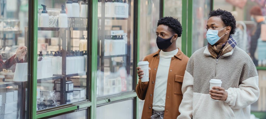 Black men window shopping coffee, masks